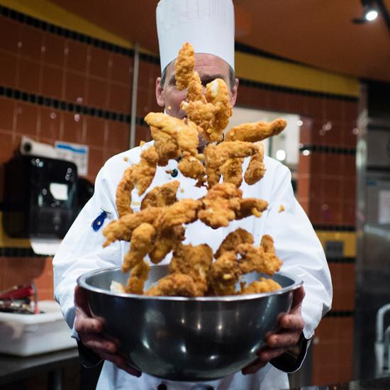 Chicken Fingers being tossed in the air